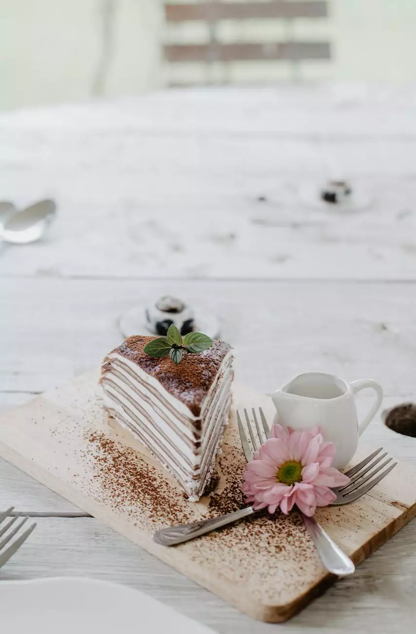 Layered cake on a wooden board beside a white pitcher